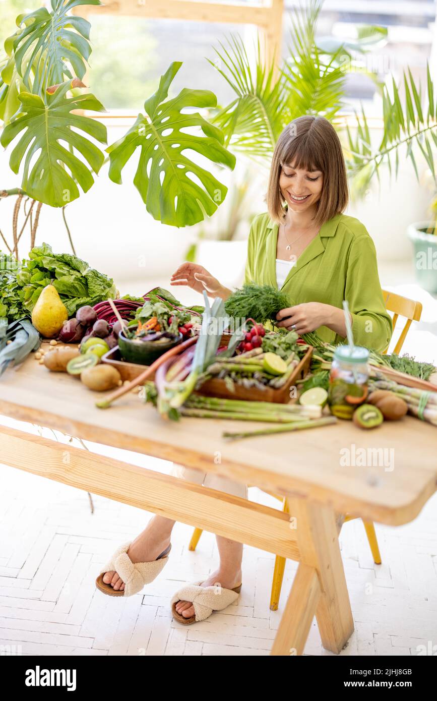 Woman with fresh healthy food ingredients indoors Stock Photo