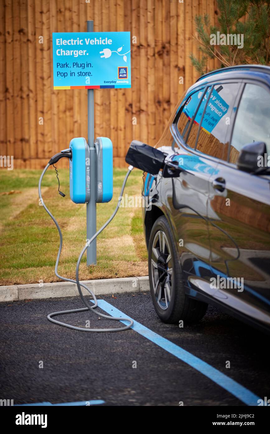 Aldi Speke customer charging their car at the EV points Stock Photo Alamy