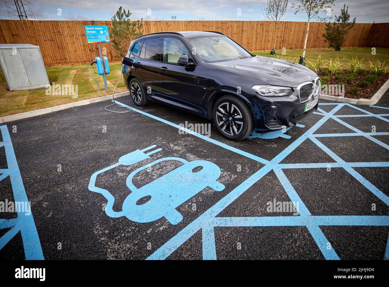 Aldi Speke customer charging their car at the EV points Stock Photo Alamy