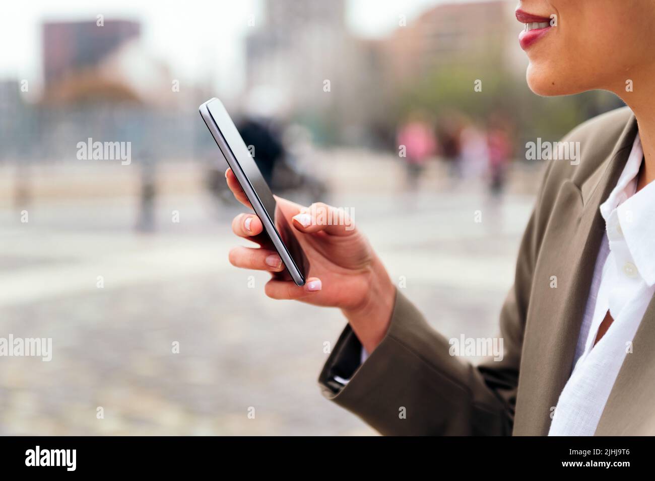 hand of an unrecognizable woman using a mobile Stock Photo
