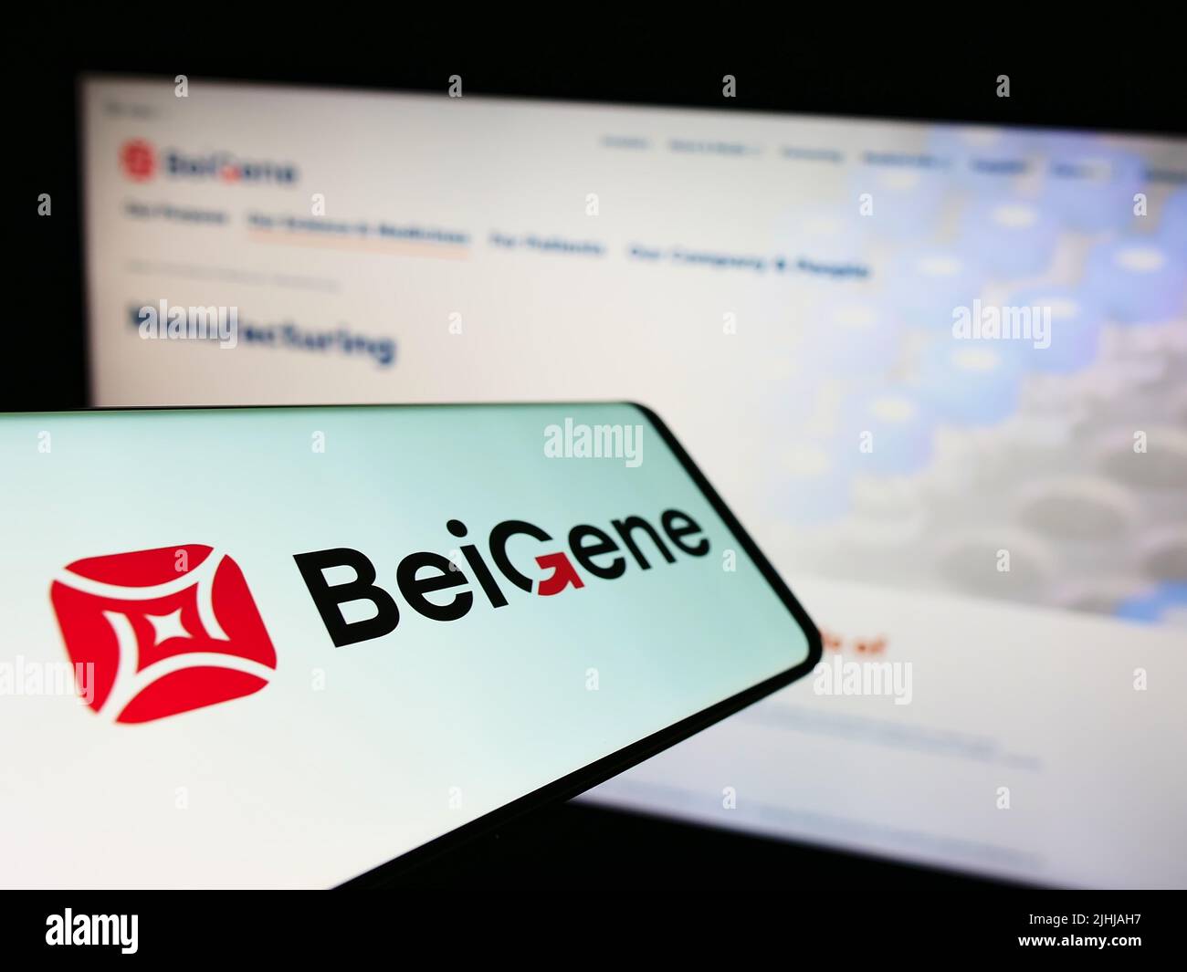 Cellphone with logo of Chinese biotechnology company Beigene Ltd. on screen in front of business website. Focus on center of phone display. Stock Photo