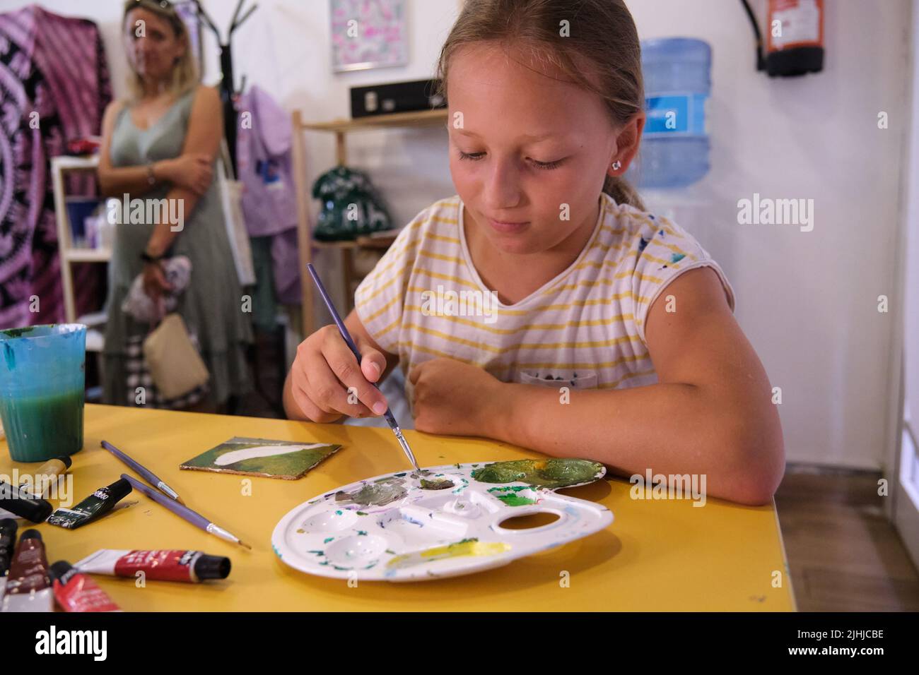 a little girl paints with paints Stock Photo - Alamy