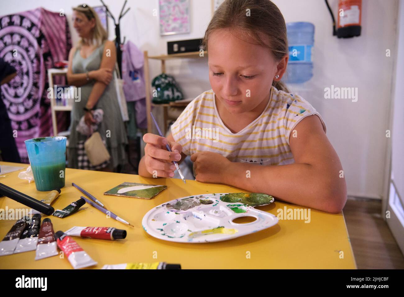 a little girl paints with paints Stock Photo - Alamy