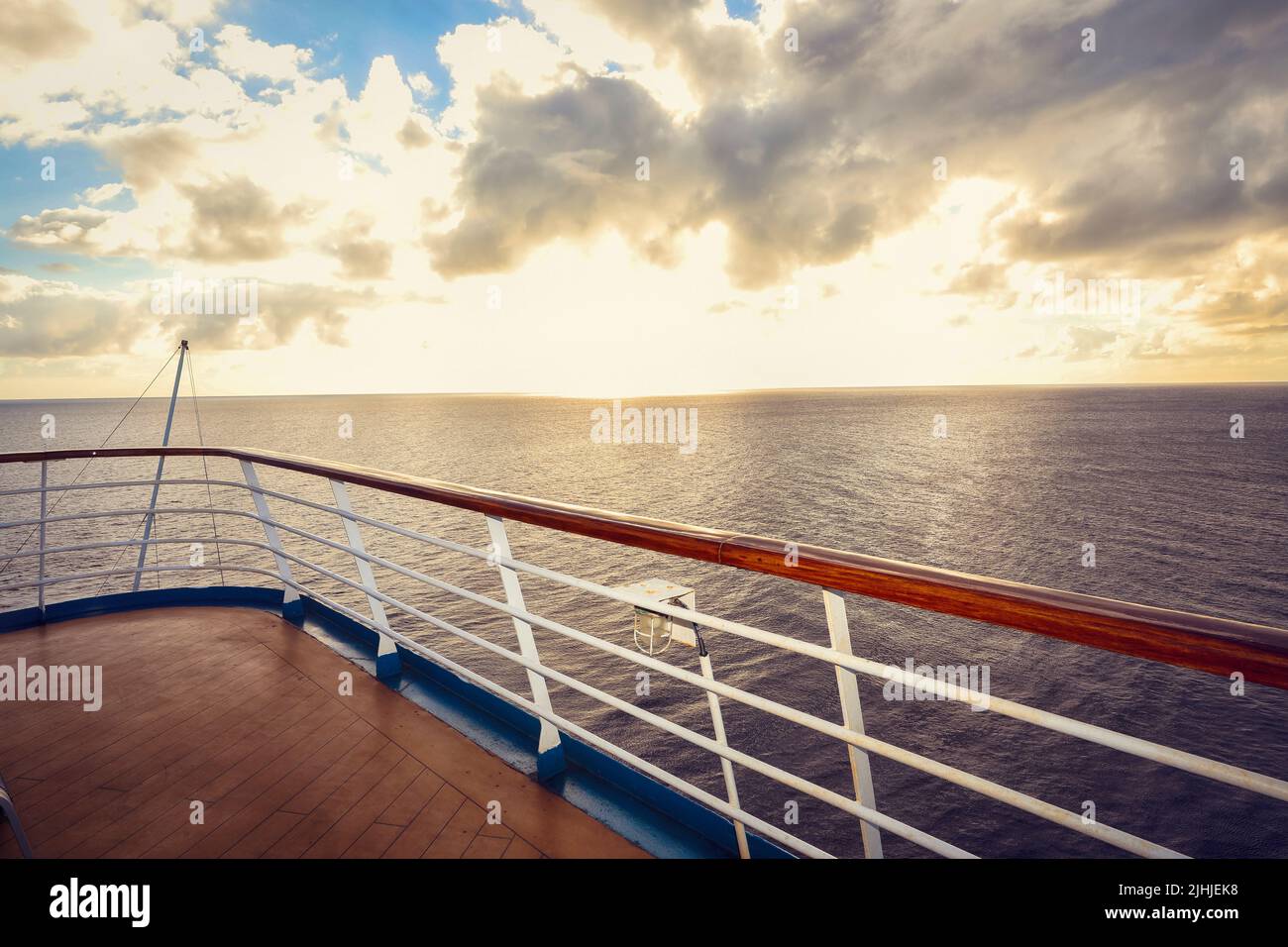 Wooden deck and railing from cruise ship. Beautiful sunset and ocean ...