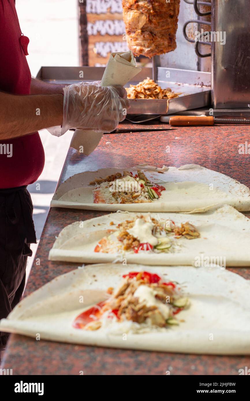 Hands of a professional chef who makes Shawarma in an arabian restaurant Stock Photo