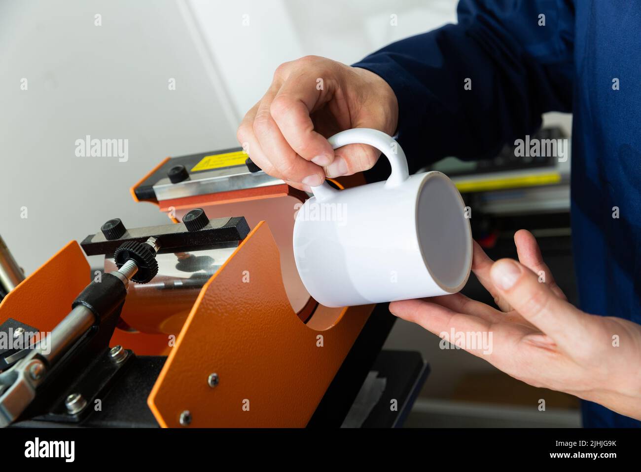 Ceramic mug drawing machine Stock Photo Alamy