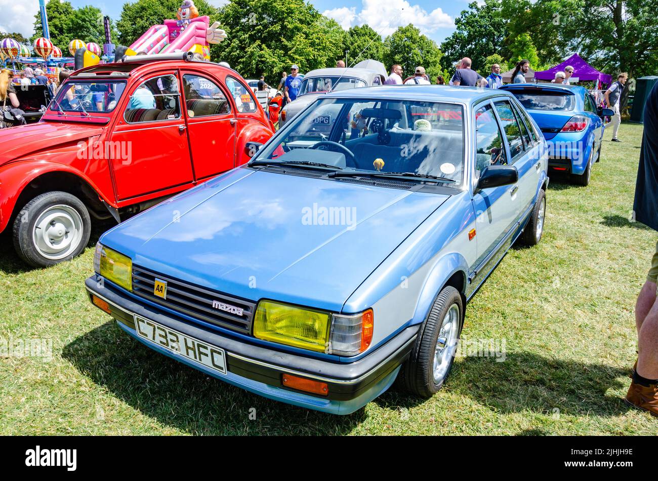 Front view of a 1985 Mazda 323 in blue at The Berkshire Motor Show