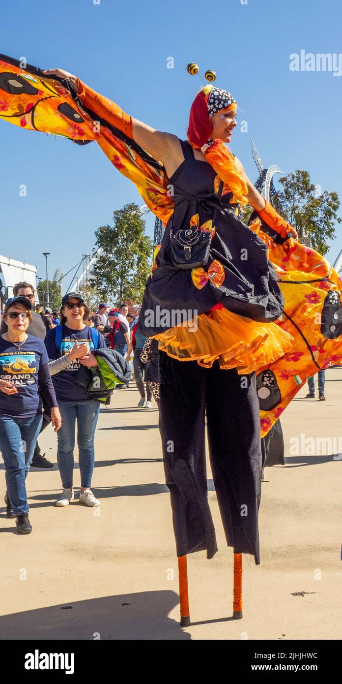 Womanon stilts in costume dressed as butterfly at AFL Grand Final 2021