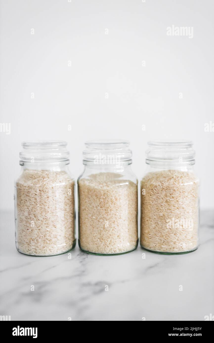 glass jar with white rice of different varieties including jasmine