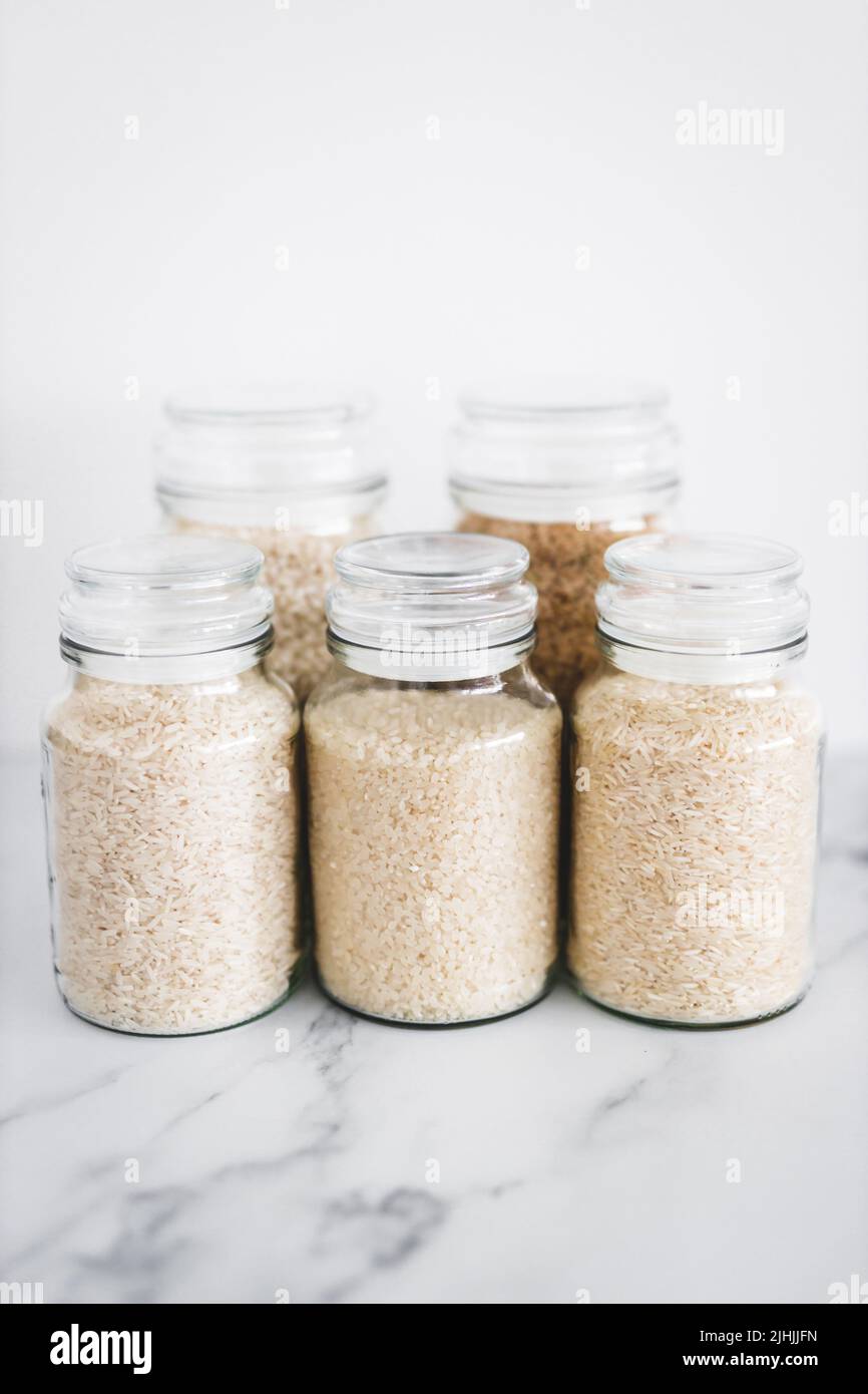 glass jar with rice of different varieties including jasmine basmati arborio sushi and brown