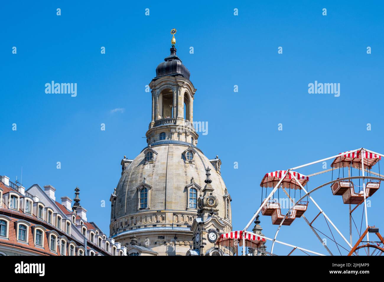 The dome of the Frauenkirche on Neumarkt, the gondolas of a Ferris wheel in the foreground Stock Photo