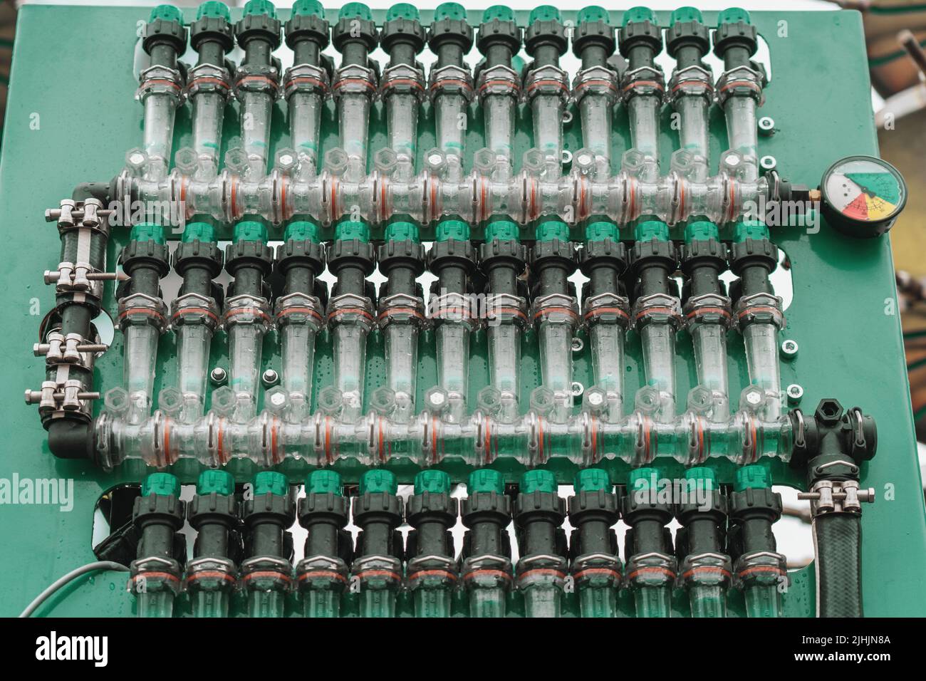 Plastic pipes, connections and pressure gauge for irrigation system or spraying agricultural fields and crops on industrial machinery. Stock Photo