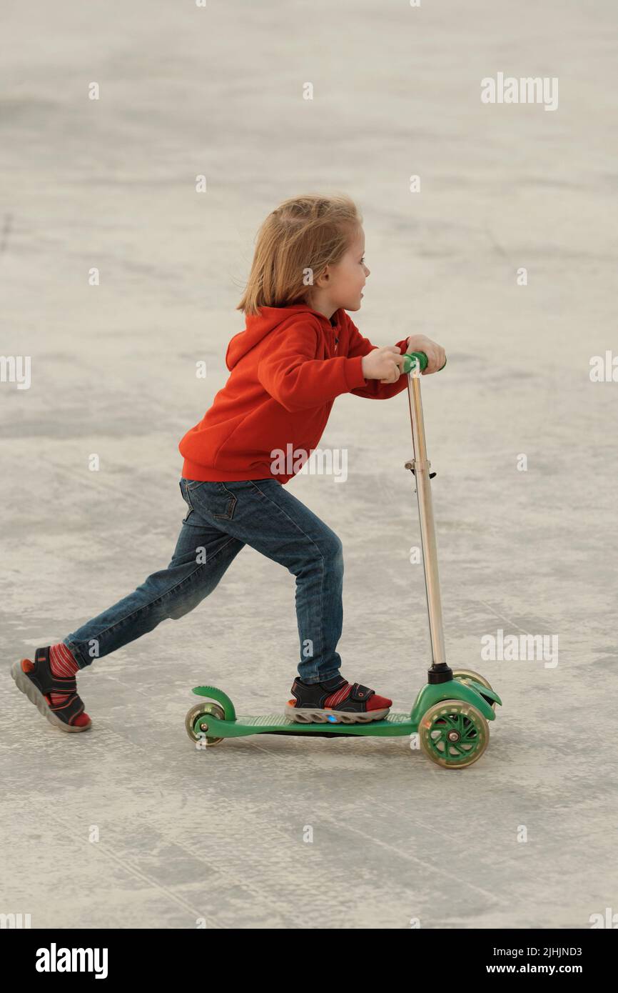 Beautiful 5yo Kid With Long Blond Hair Wearing Jeans And Red Hoodie beautiful-5yo-kid-with-long-blond-hair-wearing-jeans-and-red-hoodie