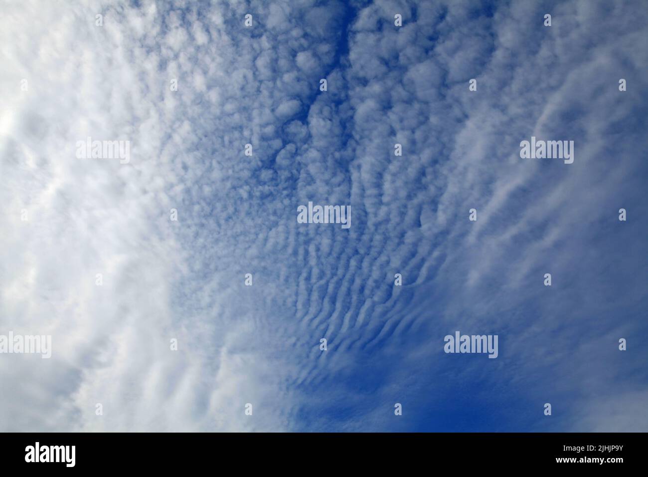 Cirrus clouds on the blue sky background. Thready and abstract sky pattern. Skies landscape i summer. Spindrift clouds and its texture. Tropospheric Stock Photo