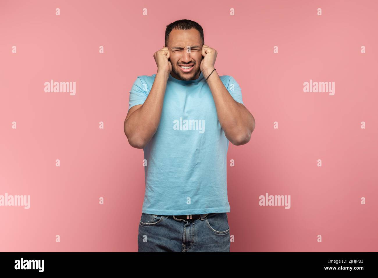 Young african americn man having sore ear, suffering from otitis, touching his inflamed head and closed eyes, free space Stock Photo