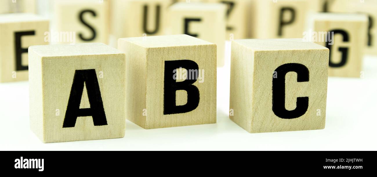 A B C letters on wooden cubes against white background Stock Photo