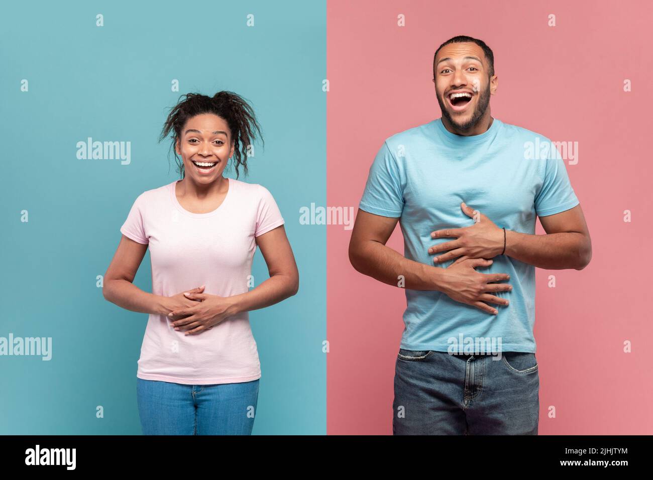 Hilarious black woman and man touching stomachs from laughter, cannot stop laughing, pink and blue background Stock Photo