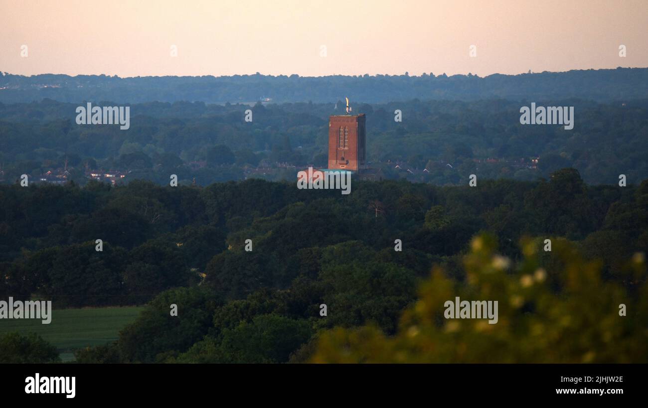 Guildford Cathedral stands out clearly in the distance as the sun sets over Surrey on one of the longest days of summer Stock Photo