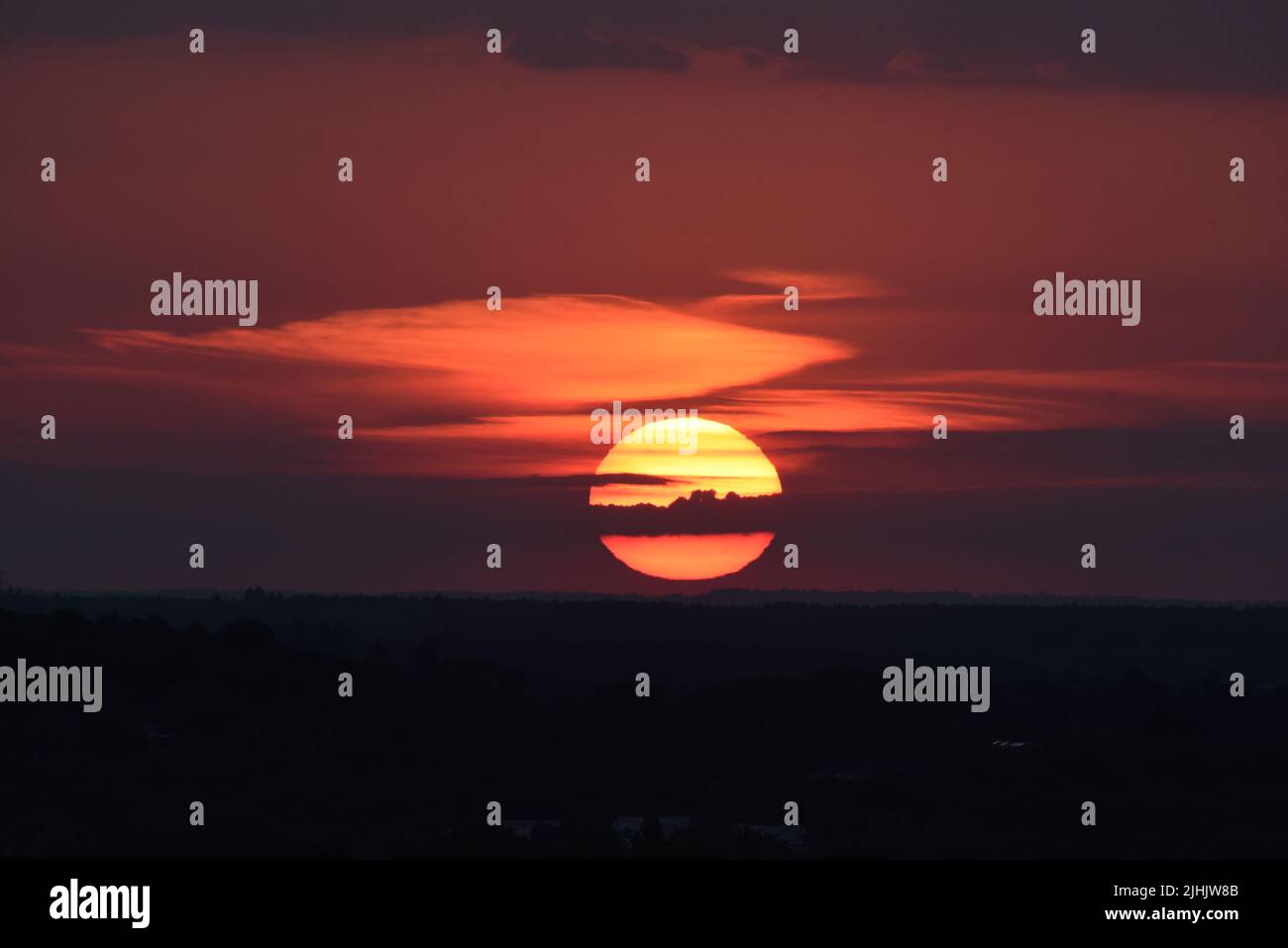 The sun setting over Surrey and Hampshire on one of the longest days of summer Stock Photo