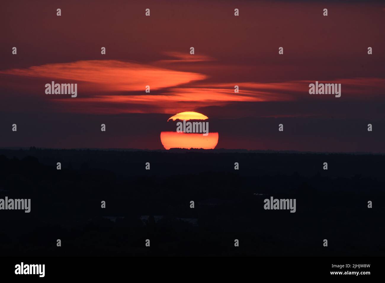The sun setting over Surrey and Hampshire on one of the longest days of summer Stock Photo