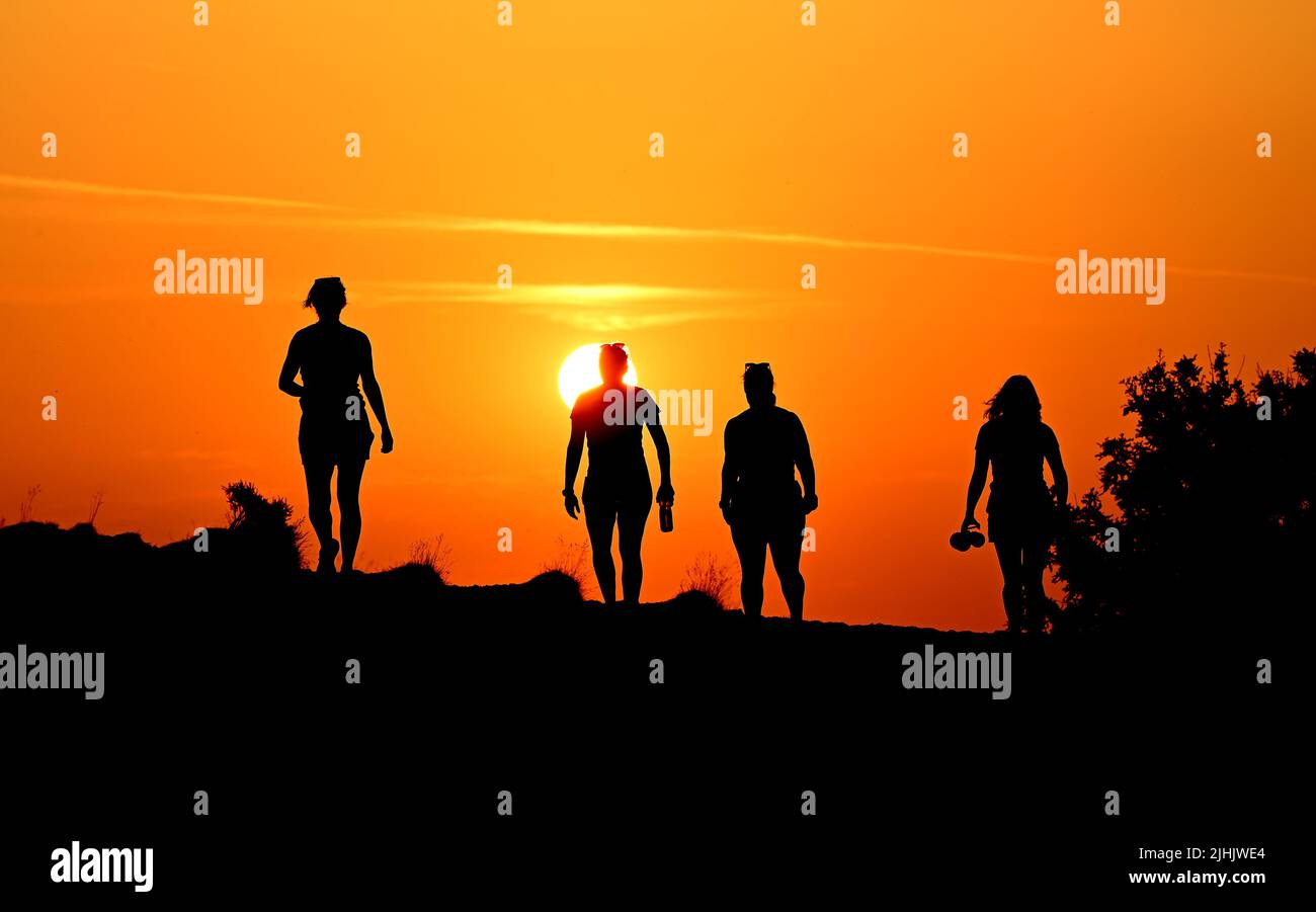 The Wrekin, Telford, Shropshire, Uk. July 19th 2022. Early risers beating the heat. Four ladies running and walking the Wrekin Hill in Shropshire at sunrise to beat the soaring temperatures in the Uk heatwave. Credit: Sam Bagnall /Alamy Live News Stock Photo