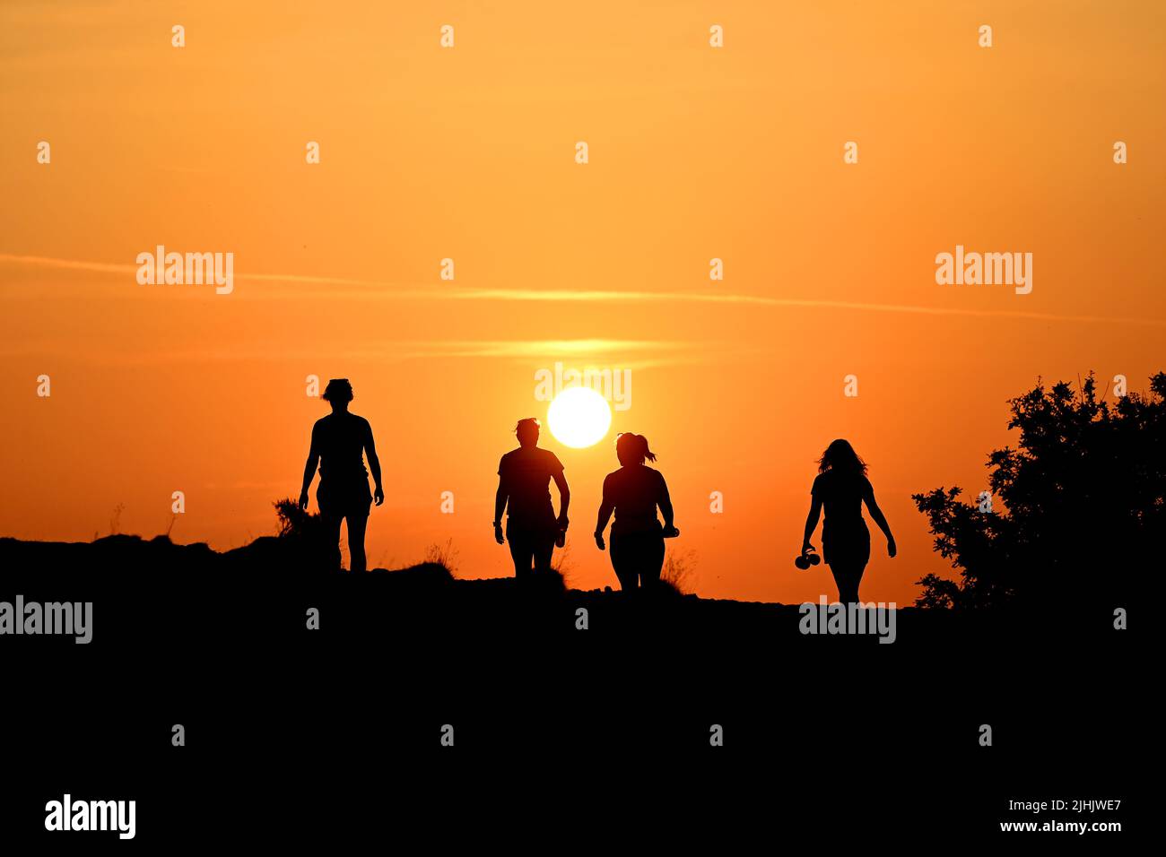 The Wrekin, Telford, Shropshire, Uk. July 19th 2022. Early risers beating the heat. Four ladies running and walking the Wrekin Hill in Shropshire at sunrise to beat the soaring temperatures in the Uk heatwave. Credit: Sam Bagnall /Alamy Live News Stock Photo