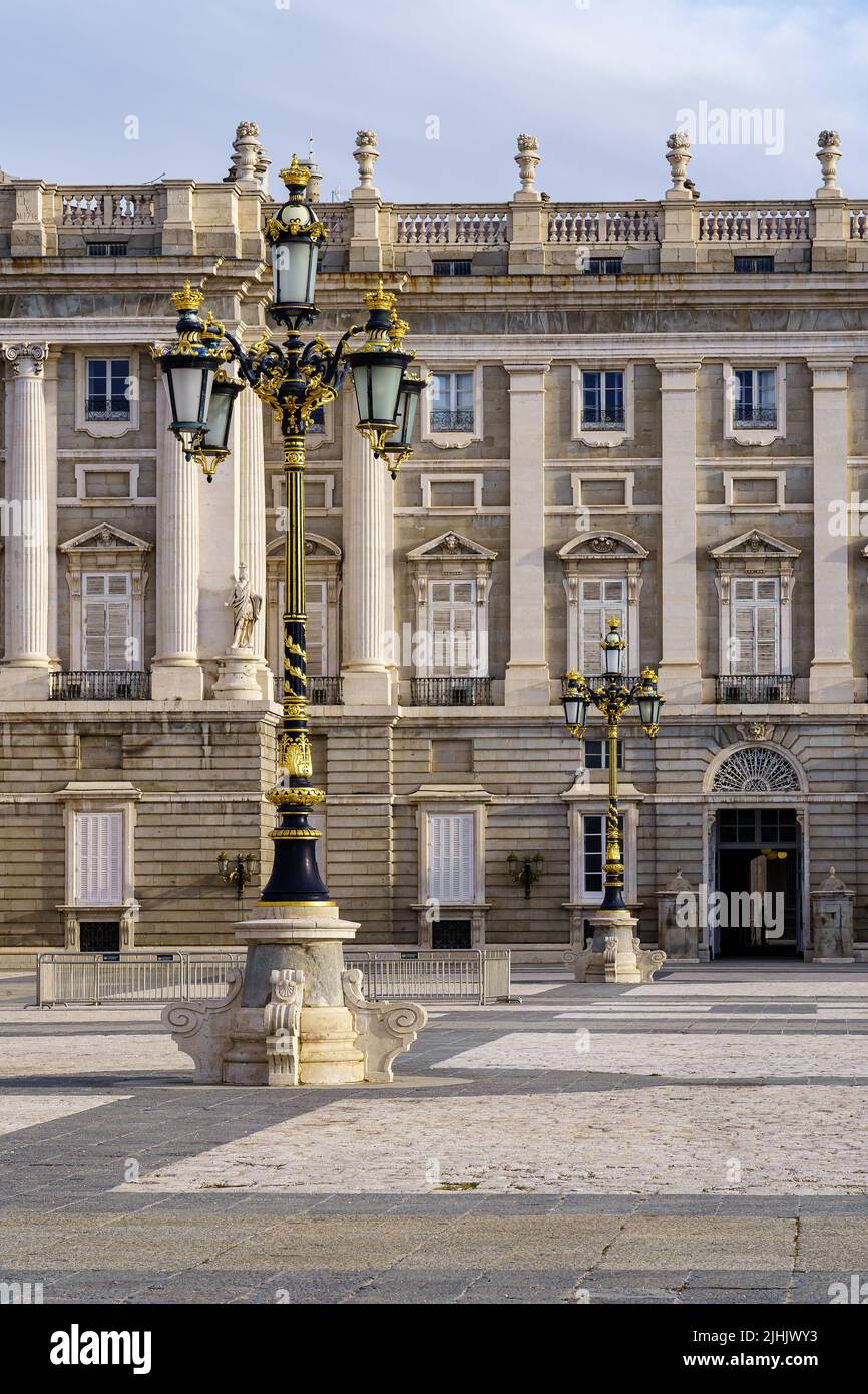 Detail of the outer courtyard of the royal palace of Madrid, with lampposts, arches and neoclassical style. Spain. Stock Photo