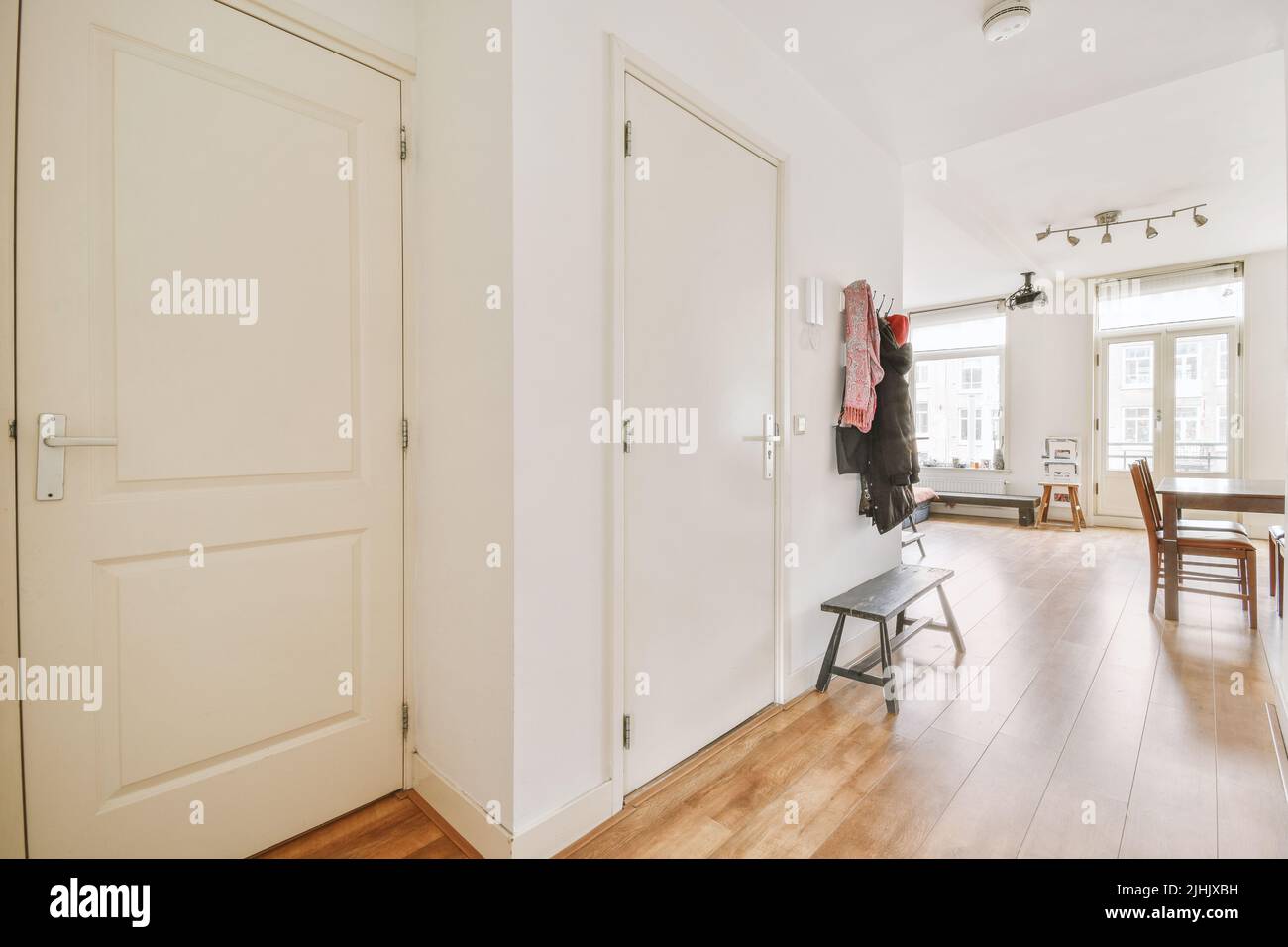 Contemporary luxury design of living room with open kitchen and dining table near window Stock