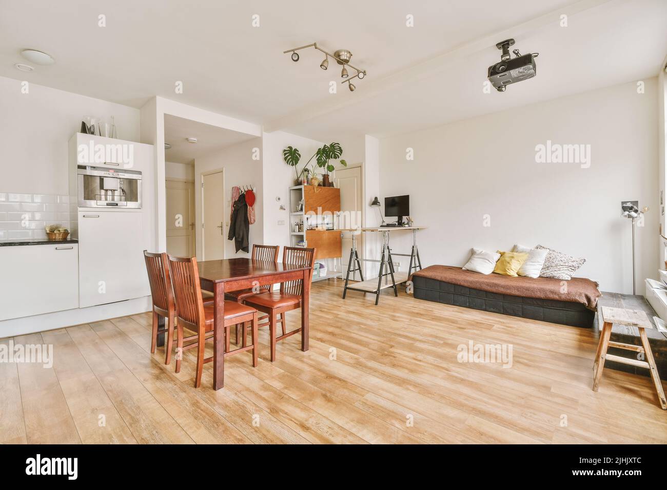 Contemporary luxury design of living room with open kitchen and dining table near window Stock