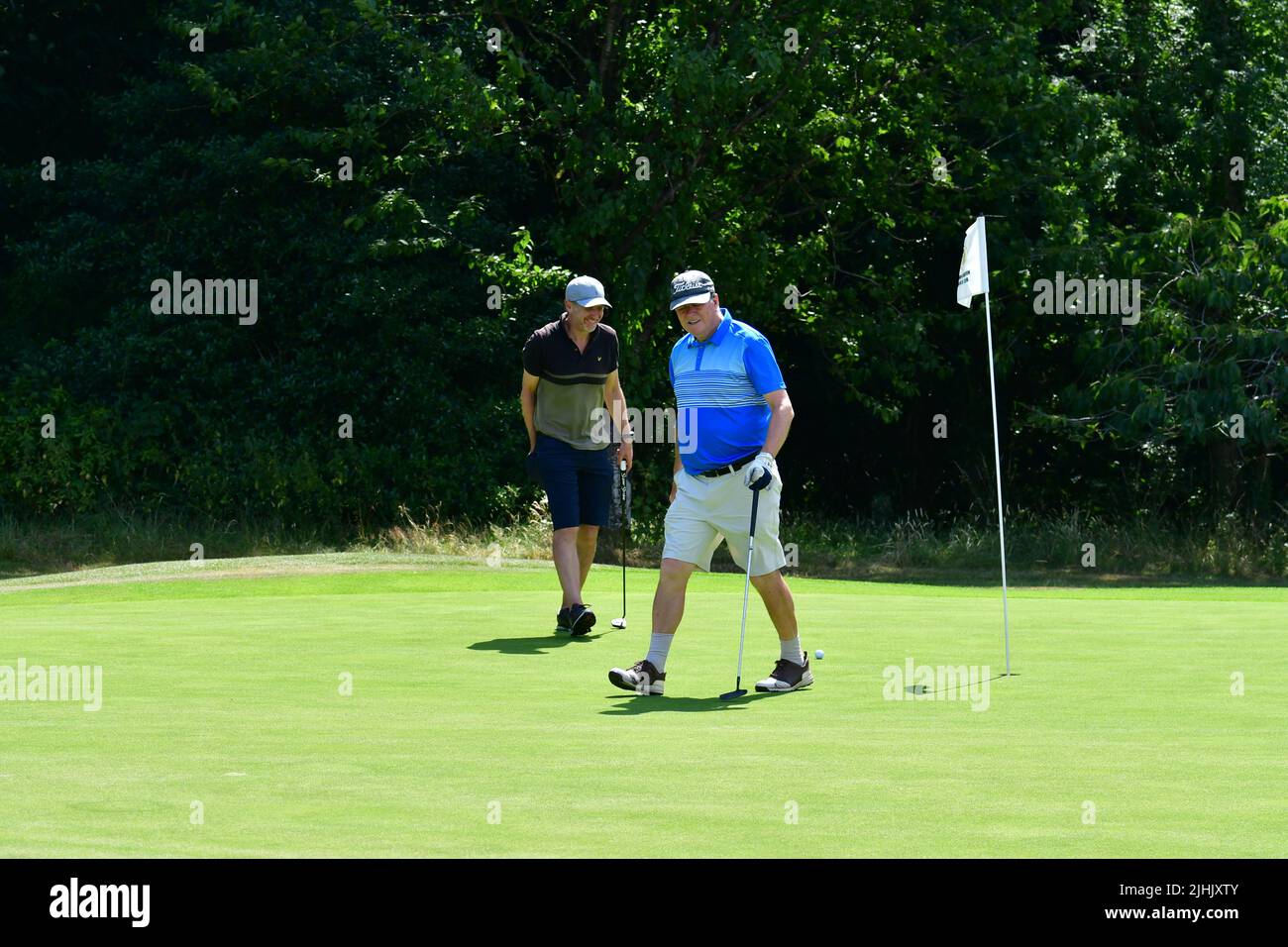 Long Ashton, UK, 19/07/2022, Hottest Day at Midday with breaking temperatures Senior golfers taking part in Competion from Long Ashton Golf Club seen at the Half Way house and Richard seen cooling off with a long cold drink on the 18th final hole. Picture Credit: Robert Timoney/Alamy Live News Stock Photo