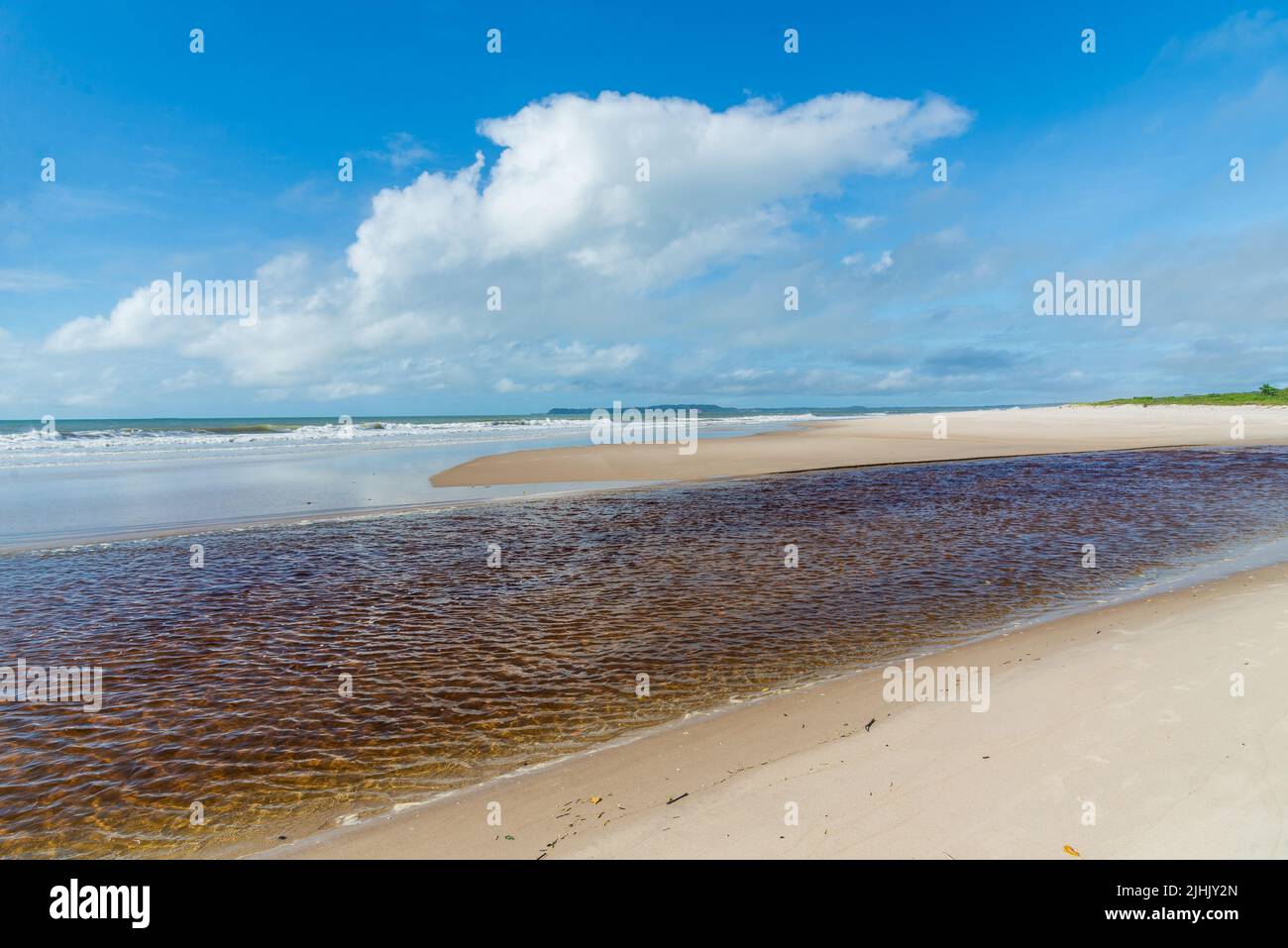 Playa Guapi Meeting of the sea and the river on the deserted beach against blue sky ...