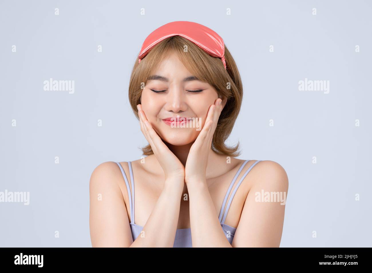 Smiling young woman with closed eyes wake up concept. Stock Photo