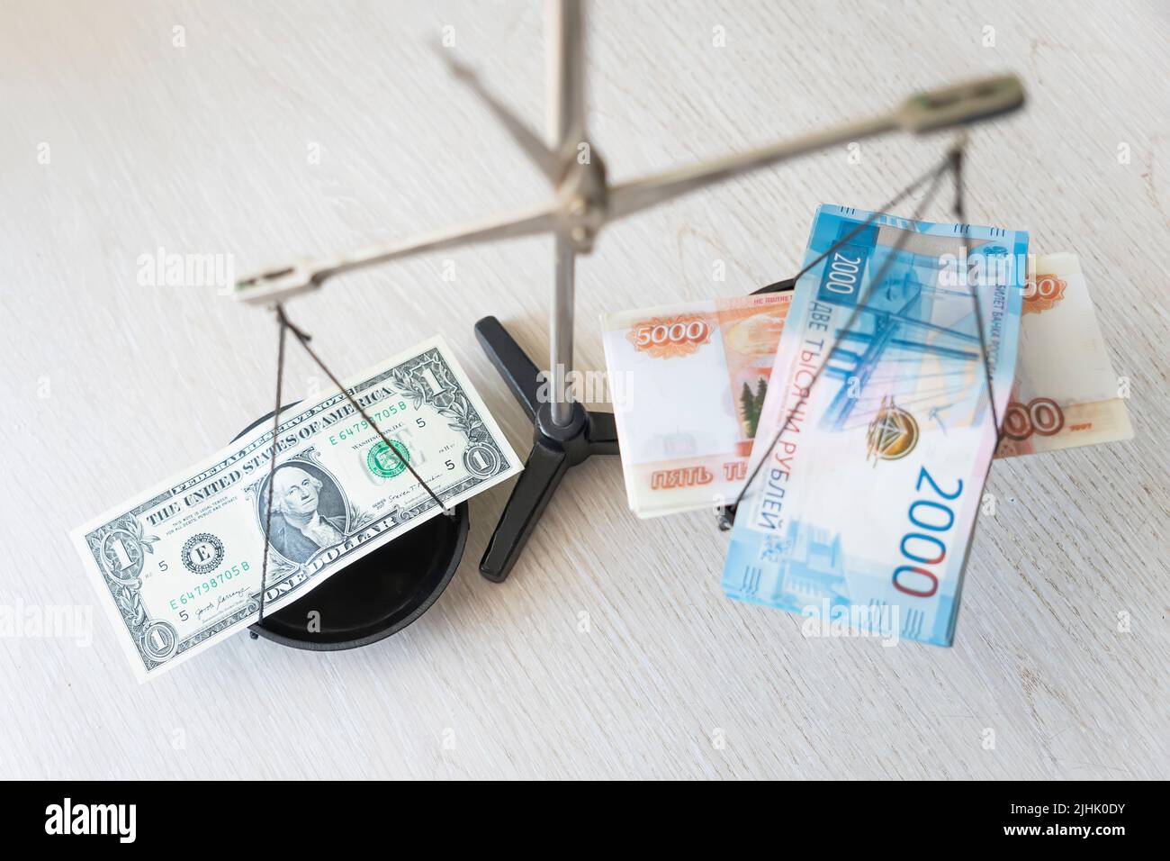 dollars and rubles lying on the scales. Economic crisis, decline of the world economy. Ruble devaluation. The fall of the Russian currency. sharp drop Stock Photo