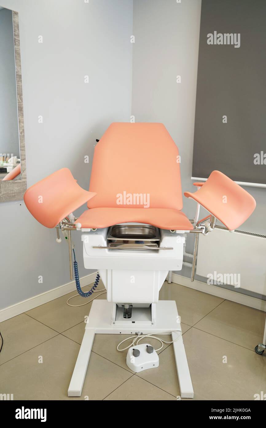 A gynecological chair standing in the center of the room in clinic ...