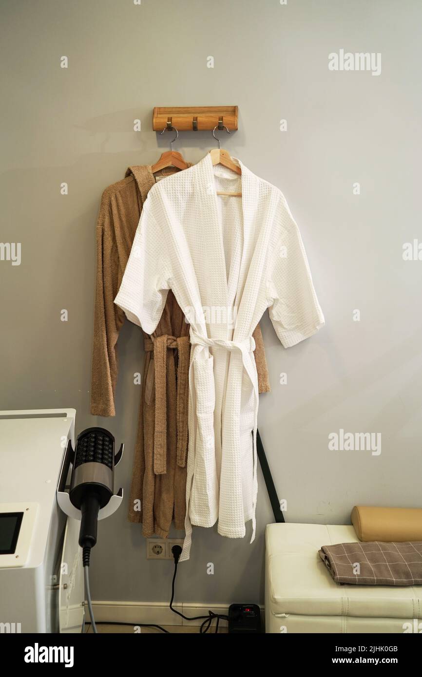 Cotton robes hanging in a cosmetology room in an antiaging clinic Stock Photo