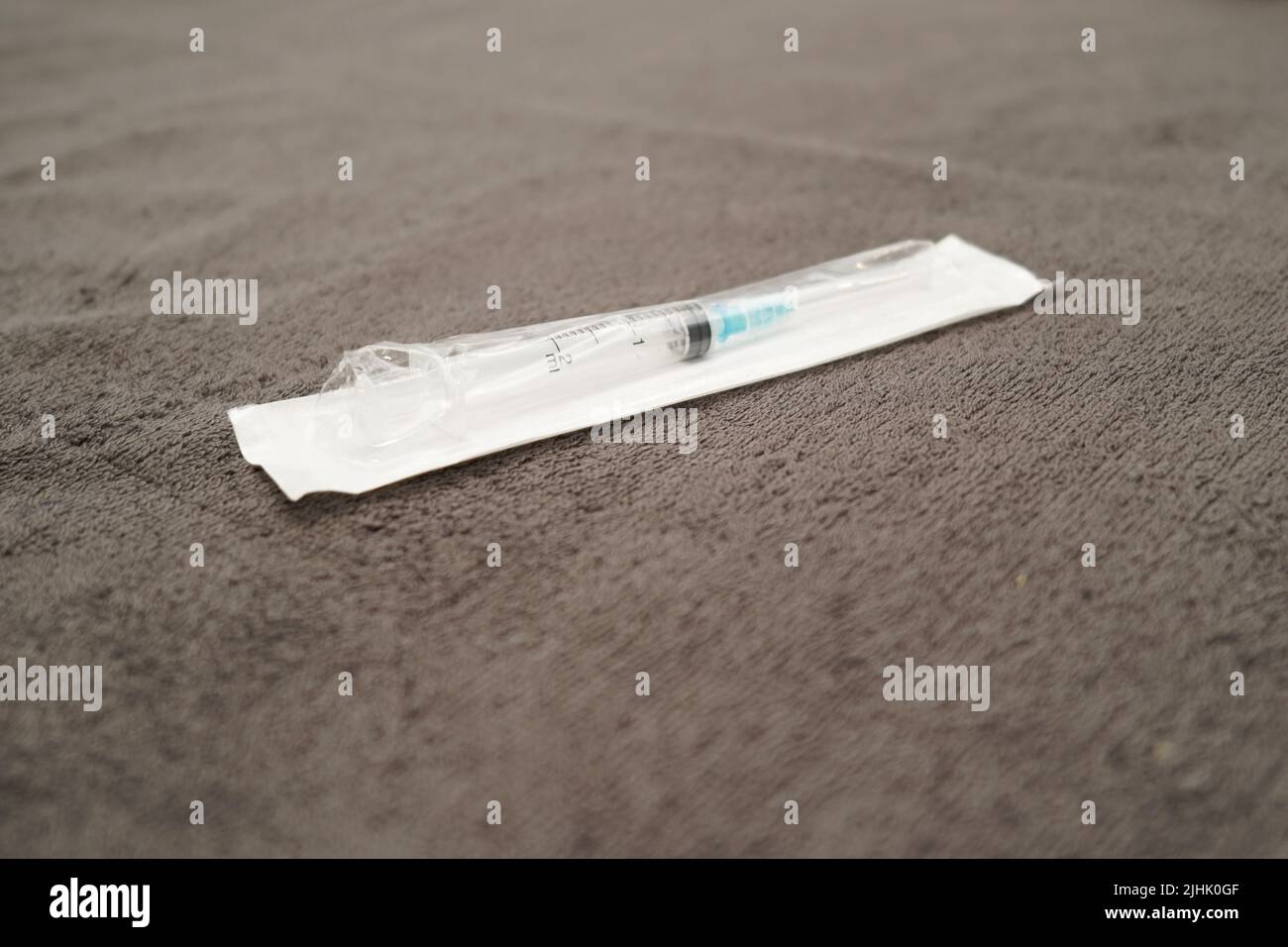 An injection needle lying on a cosmetology bed ready for the antiaging