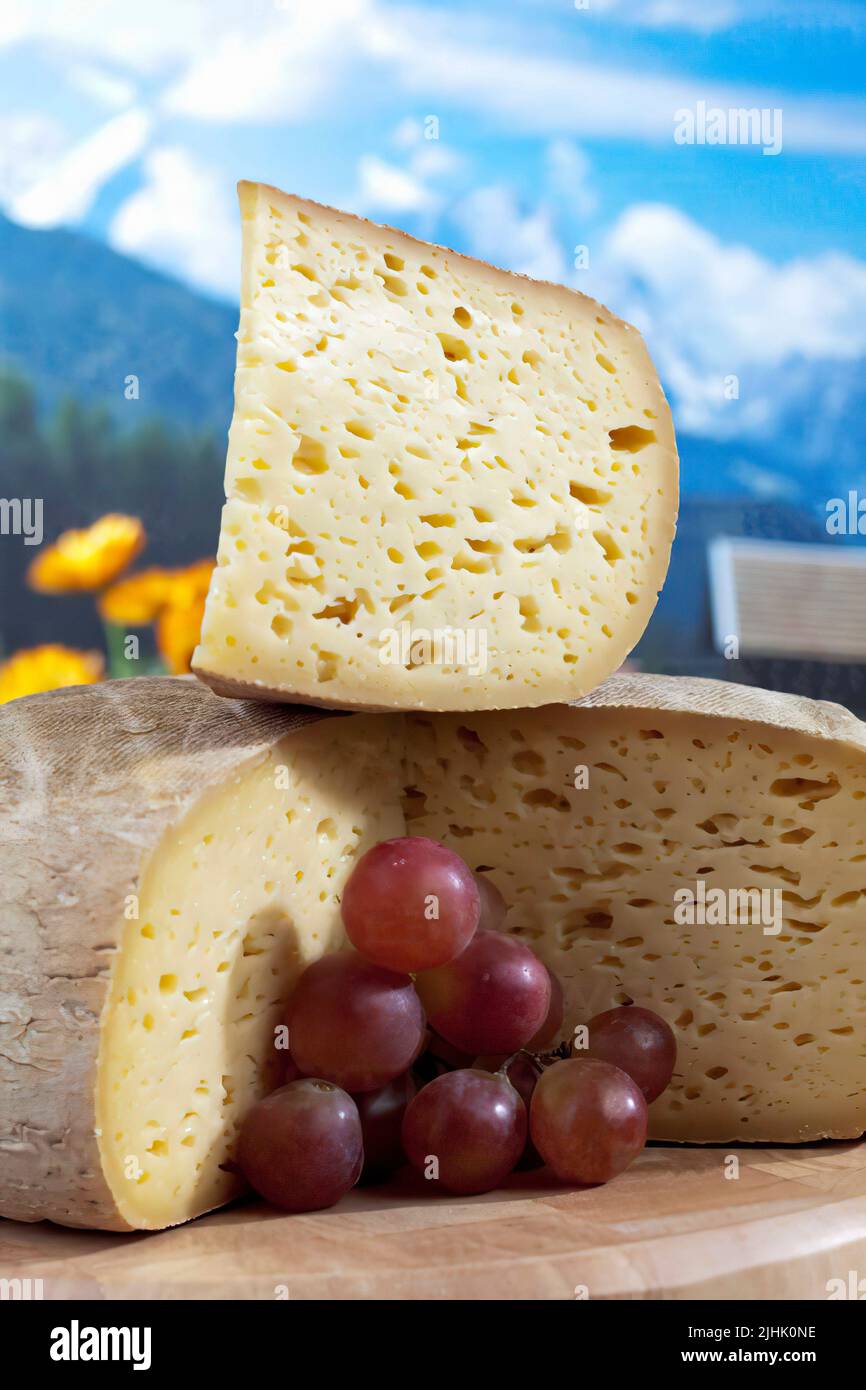 French cheese, grape and Alps background Stock Photo Alamy