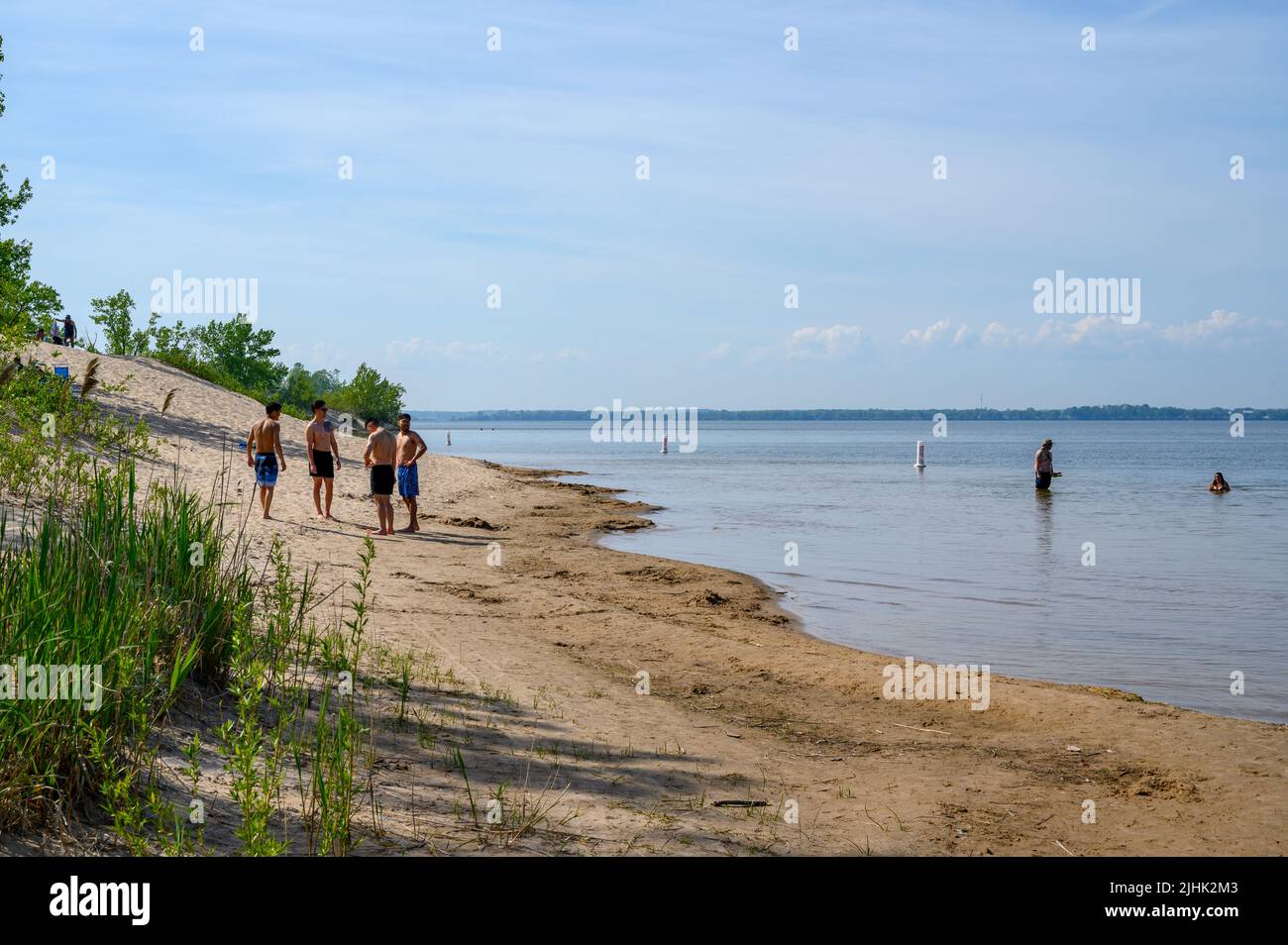 People enjoying the nice weather on the Sandbanks Dunes Beach by West