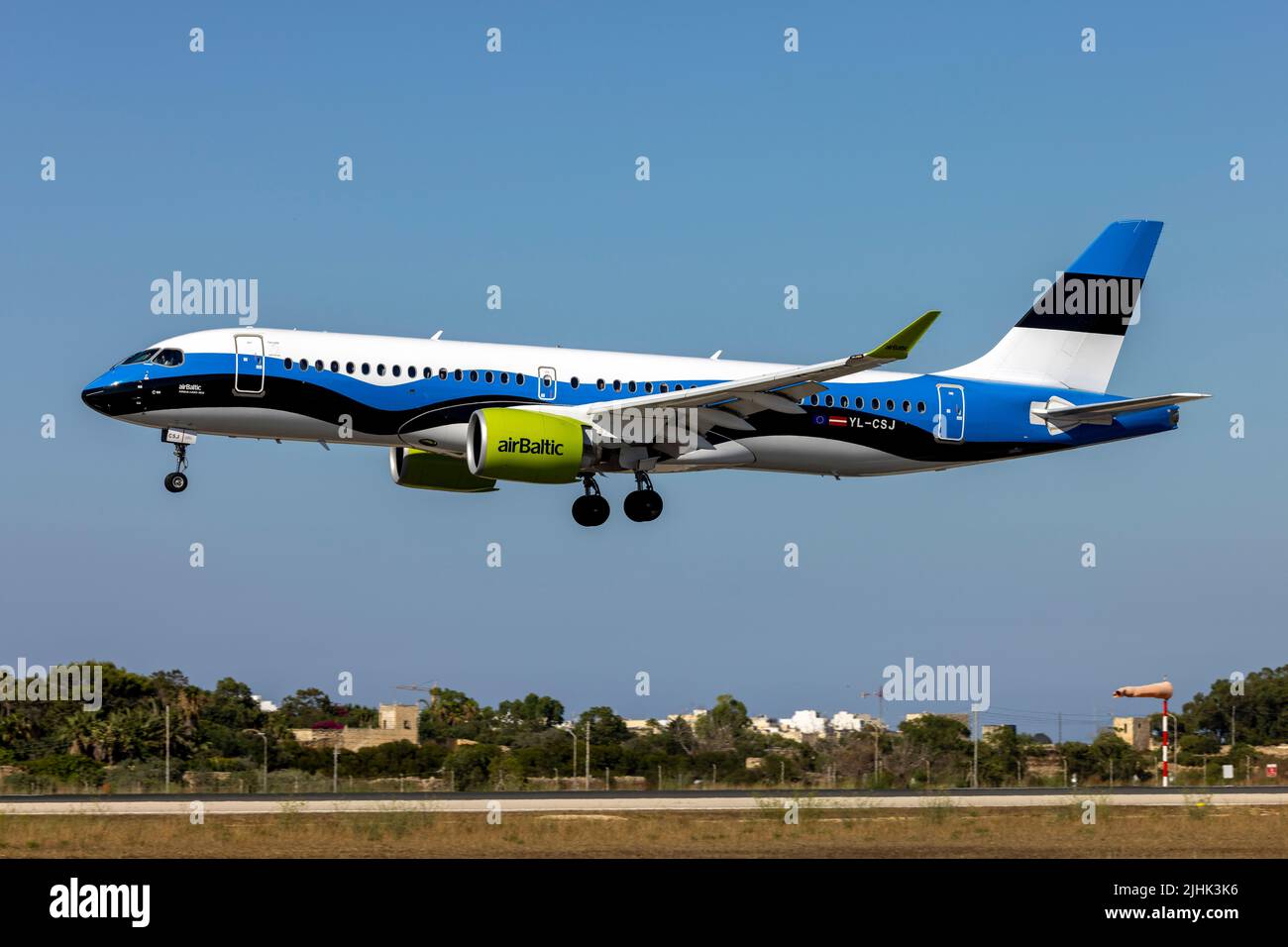 Air Baltic Airbus A220-300 (REG: YL-CSJ) in the Estonian Flag special livery, on short final for runway 31. Stock Photo