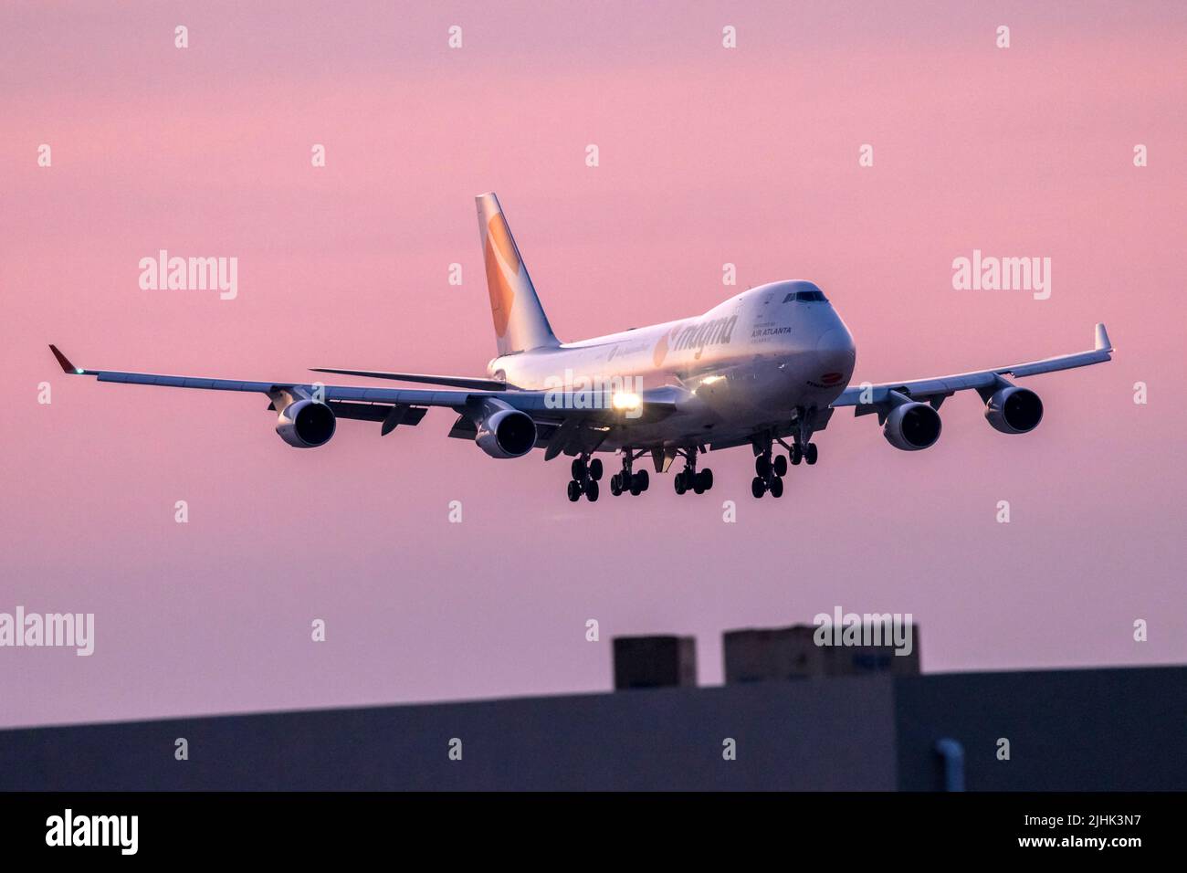 Magma (Air Atlanta Icelandic) Boeing 747-412F-SCD (REG: TF-AMC) arriving after the sun has set over the horizon. Stock Photo