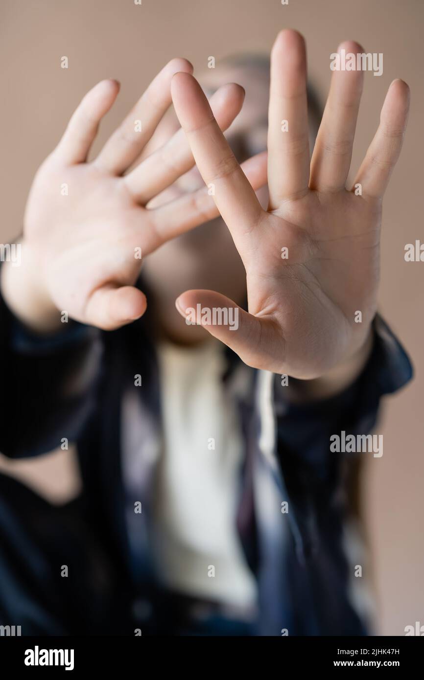 close up view of outstretched hands of blurred woman isolated on beige Stock Photo