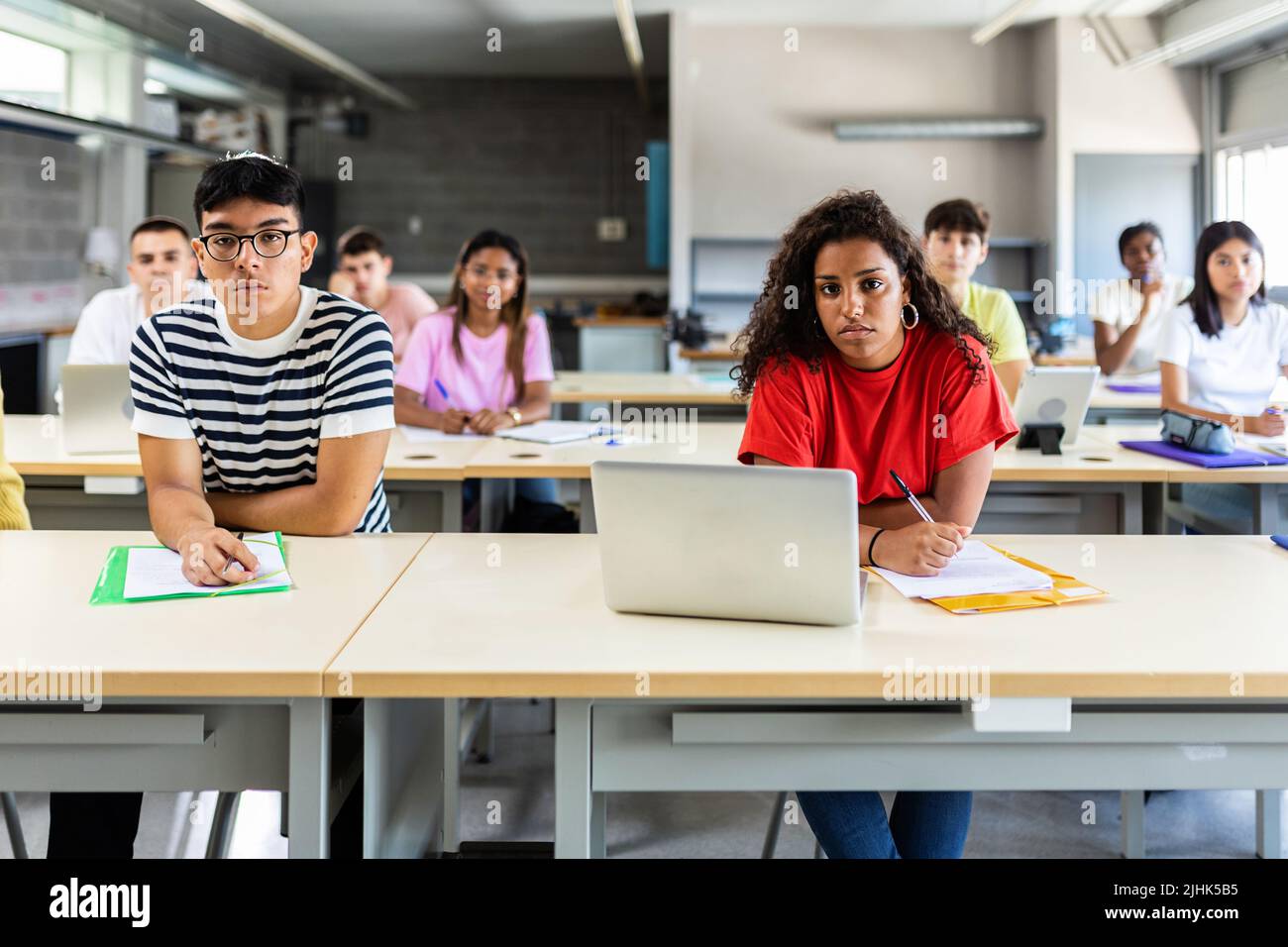 Group of multiracial students listening teacher at school classroom lesson Stock Photo