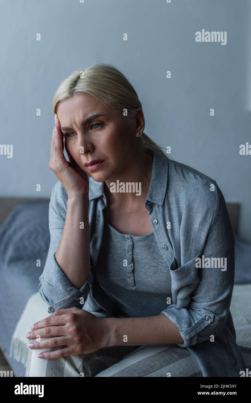 exhausted blonde woman with menopause suffering from headache in bedroom Stock Photo Alamy