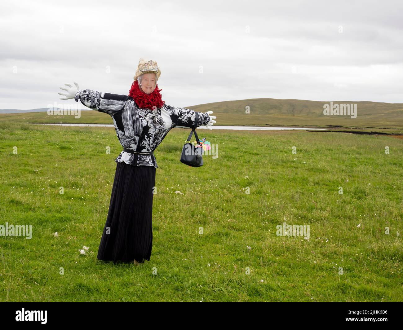 A scarecrow dressed as the Queen near Burravoe, Yell,  Shetland, Scotland, UK. Stock Photo