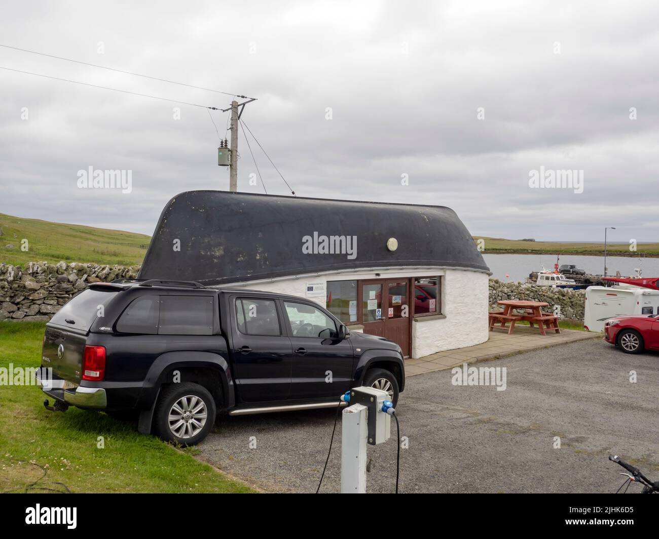 A campsite at the harbour in Burravoe, Yell,  Shetland, Scotland, UK. Stock Photo