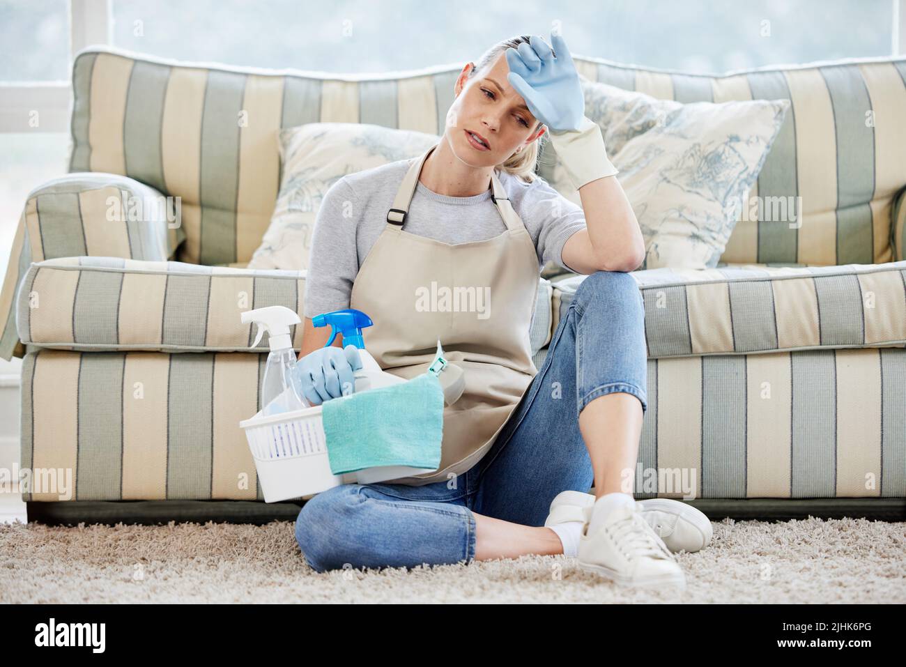 Housework... the neverending task. a young woman looking exhausted