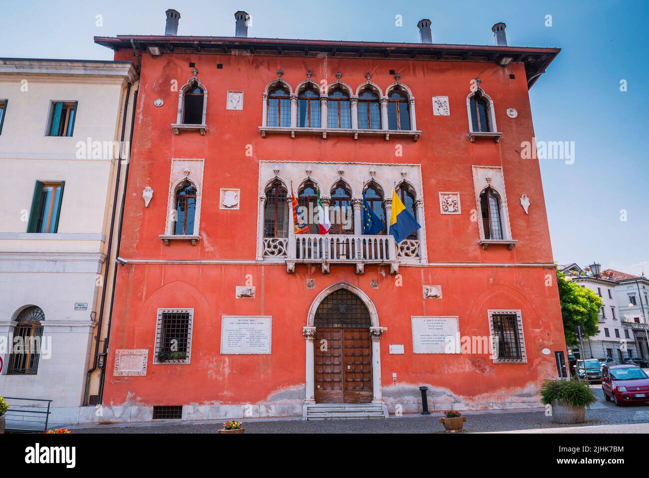 Palazzo Rosso, built in 1833 by the architect Giuseppe Segusini, in neo-Gothic style. The seat of the municipality of Belluno is located there. Bellun Stock Photo