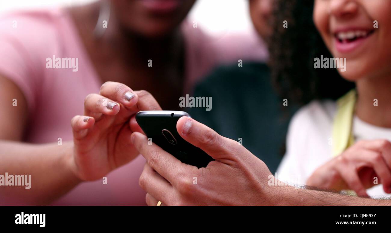 Funny happy family looking at mobile phone laughing and smiling Stock ...