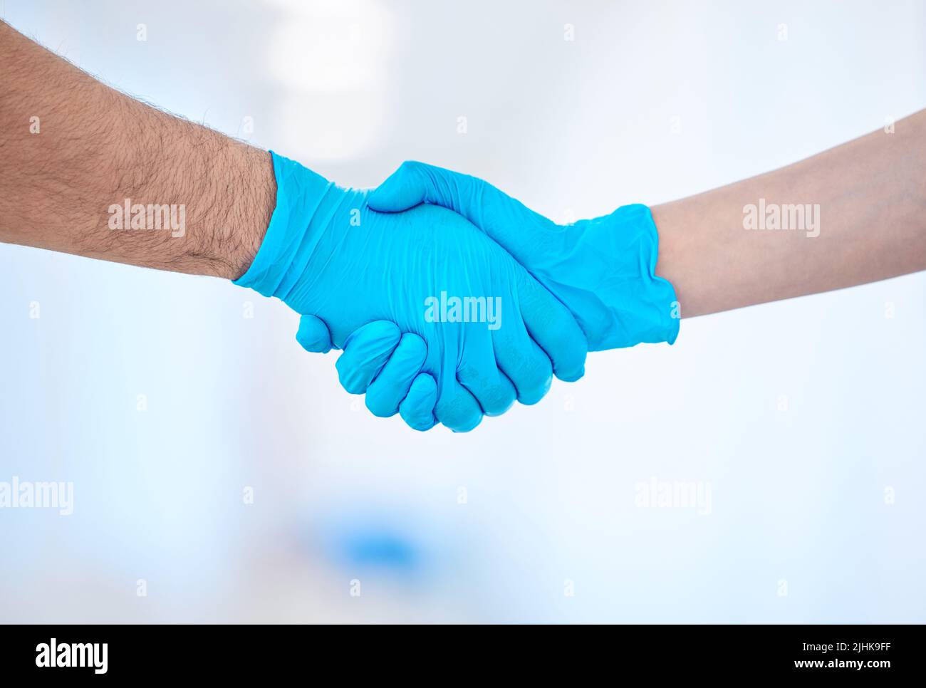 Im so happy to be here. a two dental coworkers shaking hands. Stock Photo