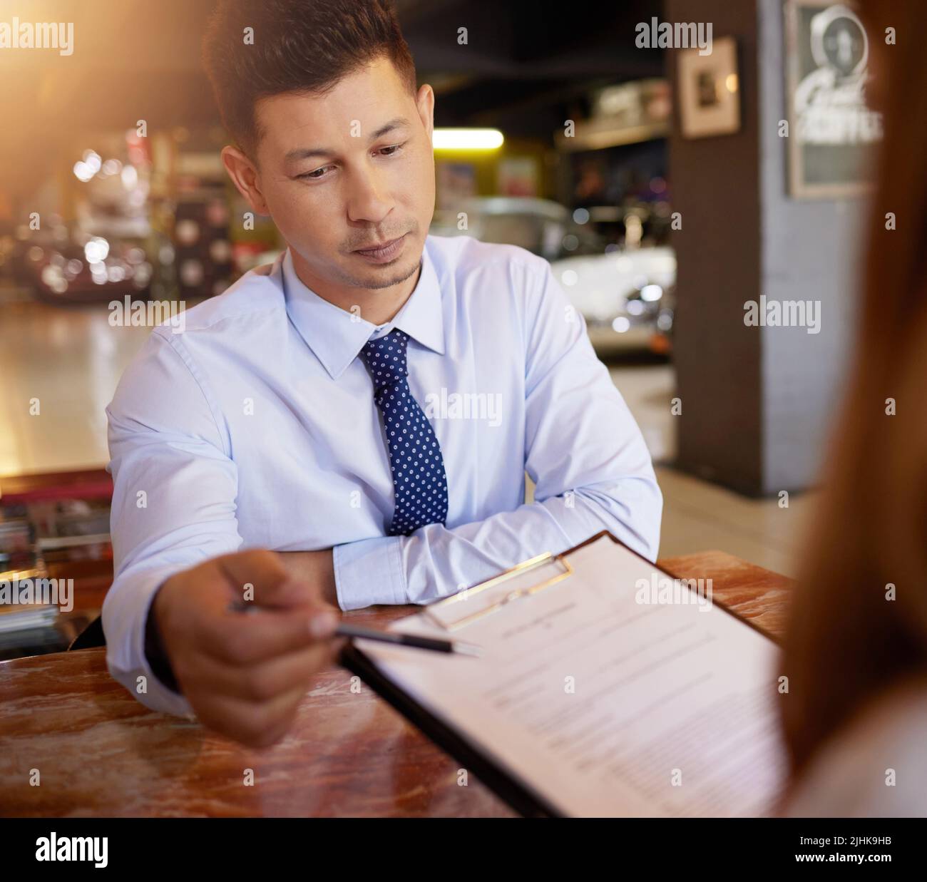 Highlighting the important points. a handsome mature male car salesman
